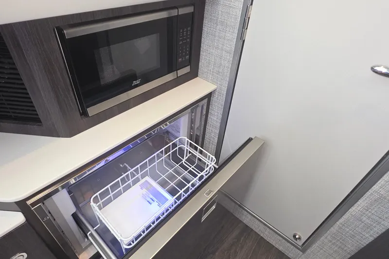 Slide: The Image of 2026 Formula 360 Crossover Bowrider I/O interior with microwave and open drawer. - 34