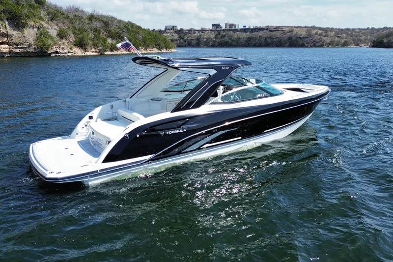 Slide: The Image of 2026 Formula 360 Crossover Bowrider I/O cruising on a scenic lake. - 4