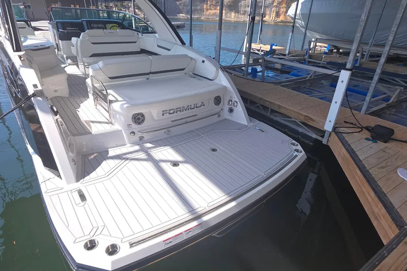 Slide: The Image of 2026 Formula 360 Crossover Bowrider I/O docked, showcasing spacious deck and seating. - 9