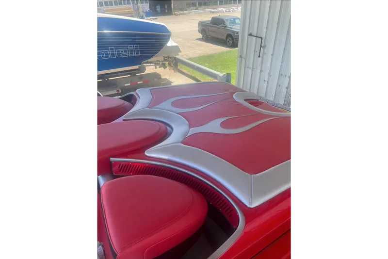 Slide: The Image of Red and silver interior of a 2005 Hustler 388 SLINGSHOT boat with flame design. - 14
