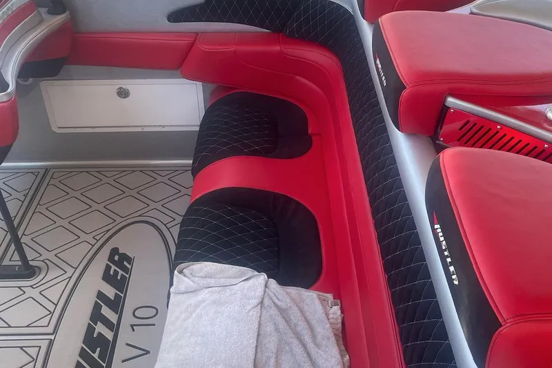 Slide: The Image of Red and black interior of a 2005 Hustler 388 SLINGSHOT boat. - 15