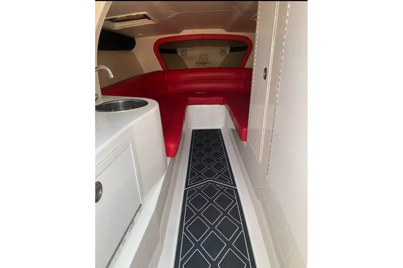 Slide: The Image of Interior of 2005 Hustler 388 SLINGSHOT with red seating and modern amenities. - 17