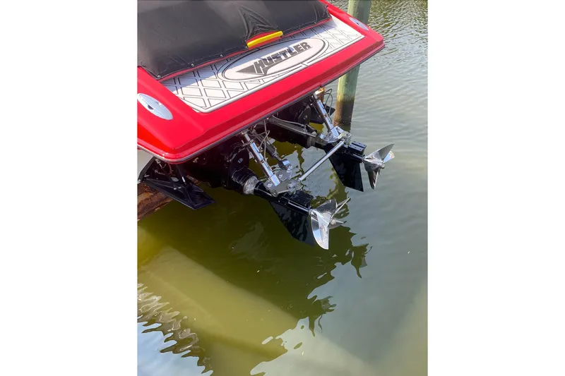 Slide: The Image of Rear view of a 2005 Hustler 388 SLINGSHOT boat with dual propellers in water. - 19