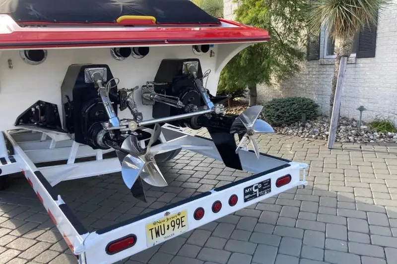 Slide: The Image of Rear view of 2005 Hustler 388 SLINGSHOT boat on trailer, showcasing dual propellers. - 6