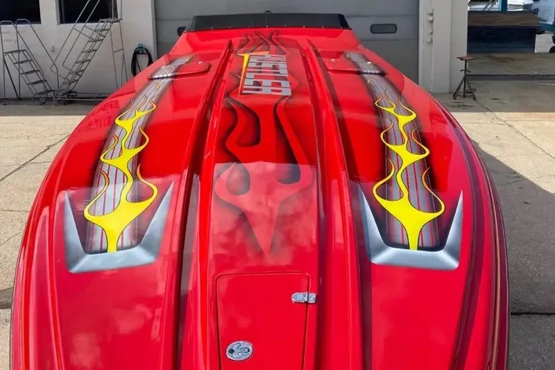 Slide: The Image of Red 2005 Hustler 388 SLINGSHOT boat with flame graphics on deck. - 7