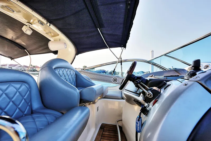 Slide: The Image of Luxurious 2008 Cranchi Mediterranee 43 yacht interior with blue leather seating and modern controls. - 16