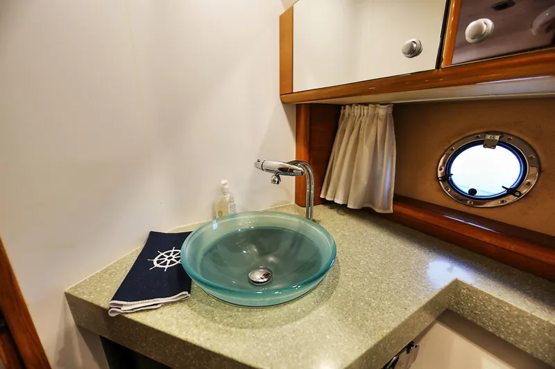 Slide: The Image of Luxurious bathroom interior of 2008 Cranchi Mediterranee 43 yacht with glass sink and porthole. - 19