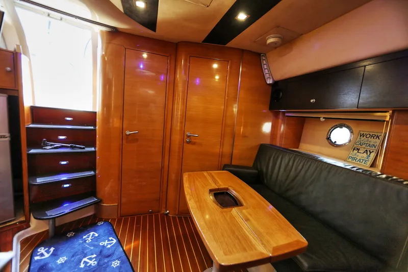 Slide: The Image of Interior of 2008 Cranchi Mediterranee 43 yacht with wooden finishes and black seating. - 31