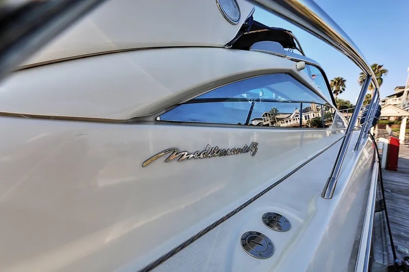 Slide: The Image of 2008 Cranchi Mediterranee 43 yacht docked, showcasing sleek design and chrome details. - 4