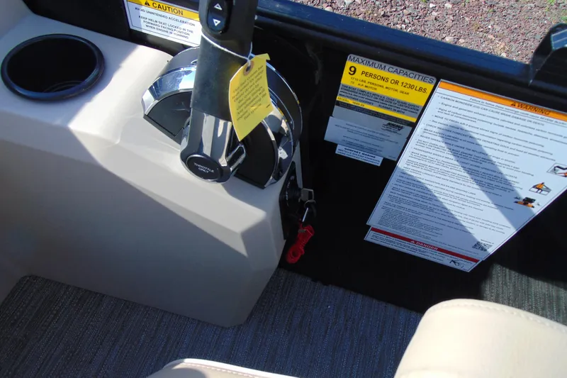 Slide: The Image of Control panel of a 2026 Godfrey EX 1680 CX boat with capacity warnings. - 14