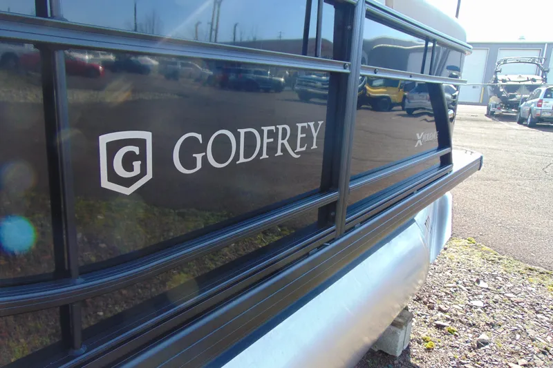 Slide: The Image of 2026 Godfrey EX 1680 CX pontoon boat with logo and sleek black design. - 4