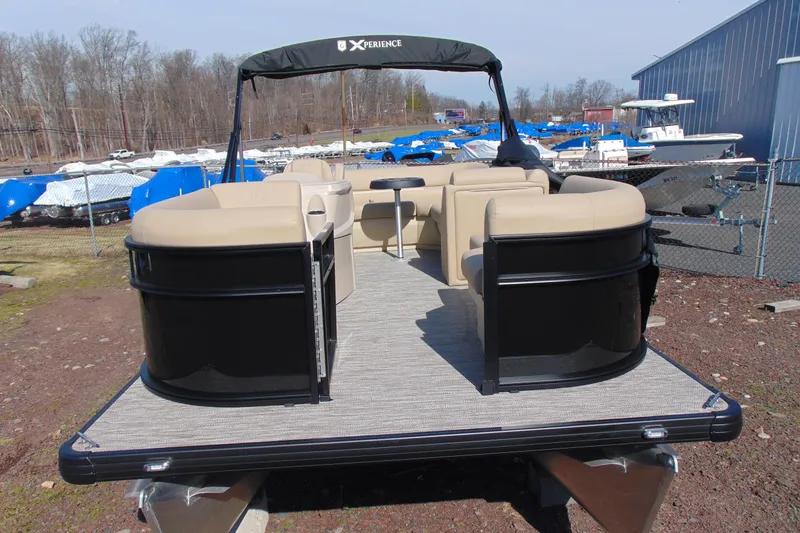 Slide: The Image of 2026 Godfrey EX 1680 CX pontoon boat with beige seating and black accents. - 5