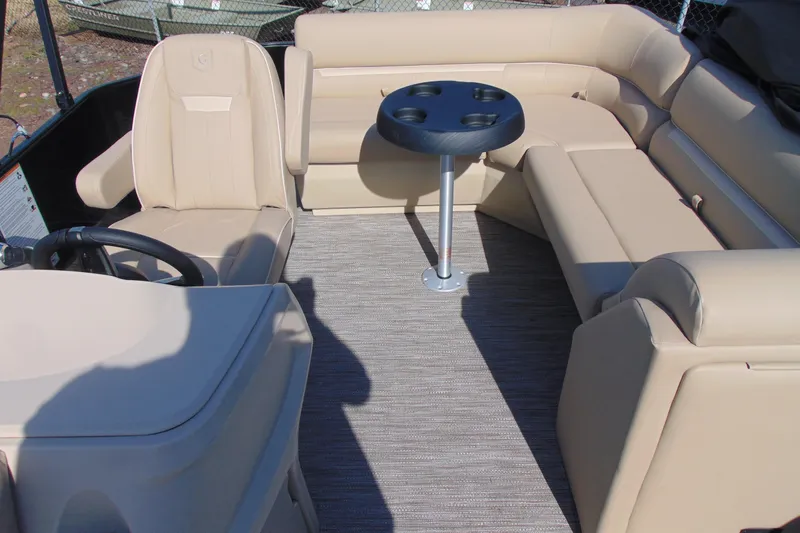 Slide: The Image of Luxurious seating area on 2026 Godfrey EX 1680 CX boat with beige upholstery and table. - 9
