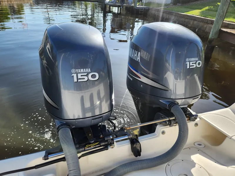 Slide: The Image of Twin Yamaha 150 outboard motors on a 2004 Pursuit 2470 Center Console boat. - 11