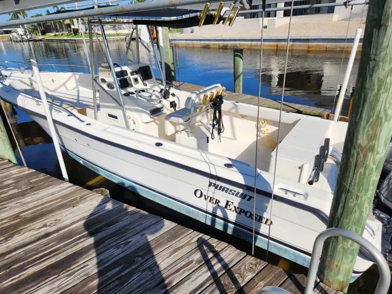 Slide: The Image of 2004 Pursuit 2470 Center Console boat docked at a marina. - 16