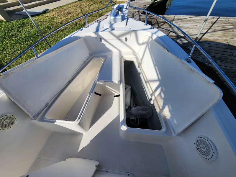 Slide: The Image of 2004 Pursuit 2470 Center Console boat with open storage compartments on deck. - 6