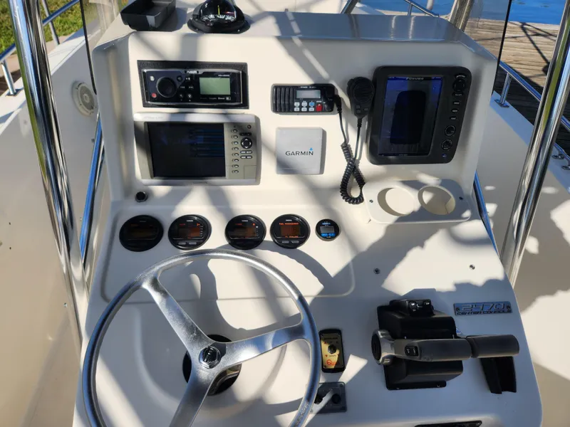 Slide: The Image of 2004 Pursuit 2470 Center Console dashboard with steering wheel, gauges, and navigation equipment. - 9