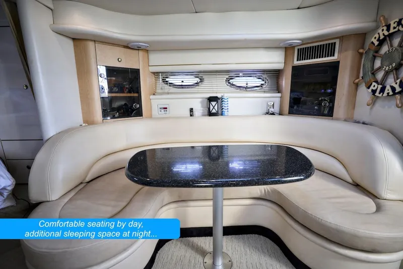 Slide: The Image of Luxurious interior of 2000 Maxum 3700 SCR yacht with convertible seating area. - 12