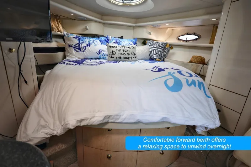 Slide: The Image of Comfortable forward berth in 2000 Maxum 3700 SCR yacht, featuring cozy bedding and nautical decor. - 15