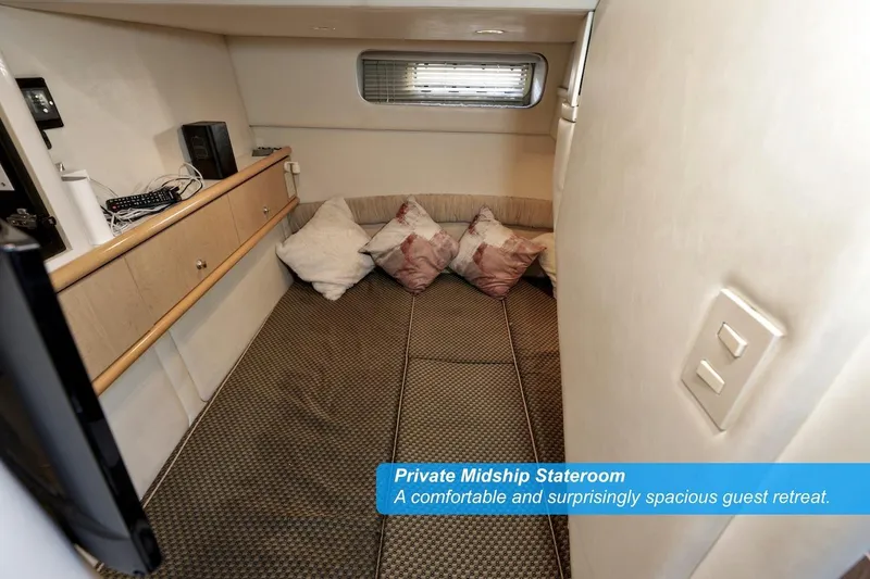 Slide: The Image of Private midship stateroom in 2000 Maxum 3700 SCR, featuring cozy bedding and ample storage. - 16
