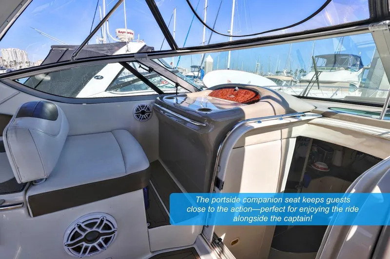 Slide: The Image of 2000 Maxum 3700 SCR yacht interior with portside companion seat and marina view. - 7