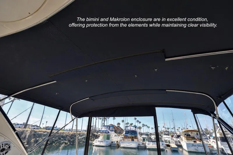 Slide: The Image of Bimini and Makrolon enclosure on 2000 Maxum 3700 SCR, marina view in background. - 8