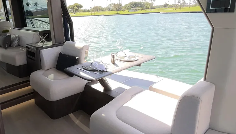 Slide: The Image of Interior dining area of 2024 Galeon 560 Fly yacht with waterfront view. - 11
