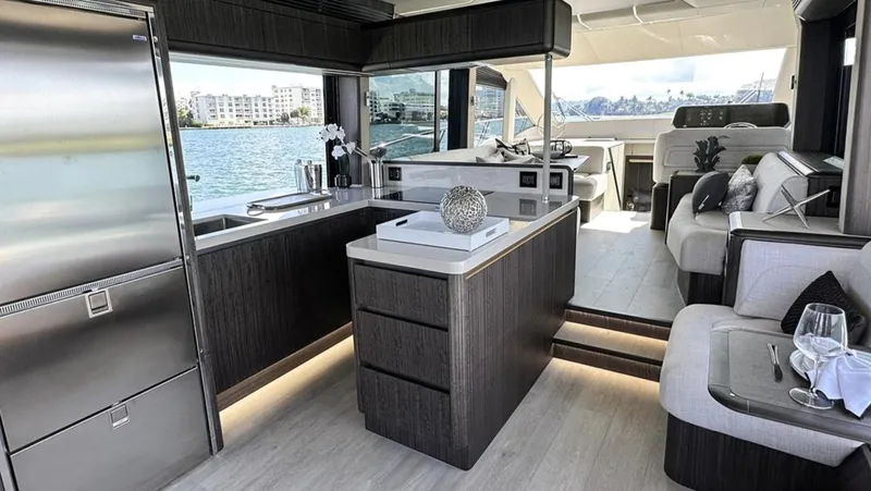 Slide: The Image of Luxurious interior of 2024 Galeon 560 Fly yacht with modern kitchen and seating area. - 13