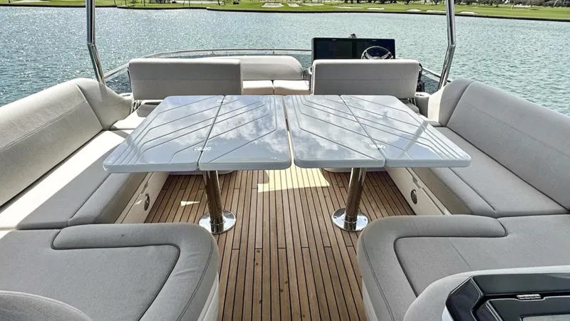 Slide: The Image of Luxury seating area on the 2024 Galeon 560 Fly yacht with a sleek dining table. - 9