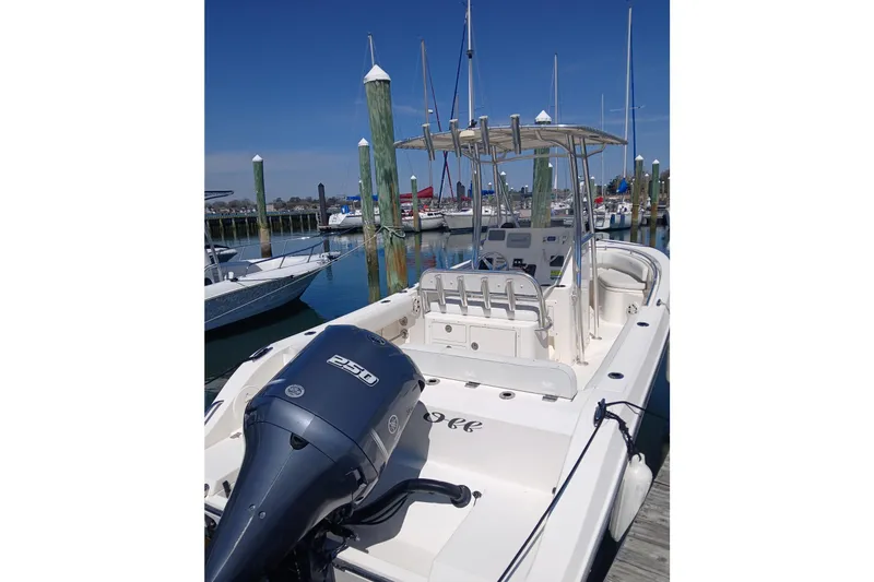 Slide: The Image of 2021 Cobia 237 Center Console boat docked at marina with Yamaha outboard motor. - 6