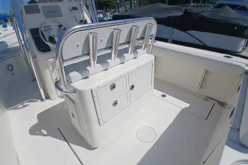 Slide: The Image of 2021 Cobia 237 Center Console boat interior with rod holders and storage compartments. - 7