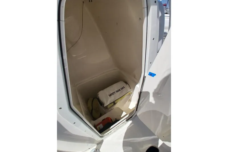 Slide: The Image of Storage compartment in 2021 Cobia 237 Center Console boat with safety gear bag. - 9