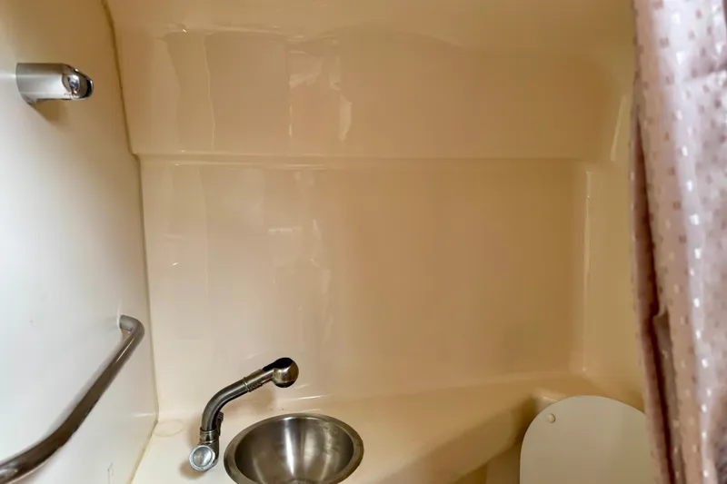 Slide: The Image of Bathroom interior of 2007 Larson Cabrio 274 boat with sink and shower. - 13