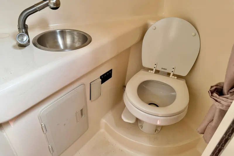 Slide: The Image of 2007 Larson Cabrio 274 boat bathroom with sink and toilet. - 14