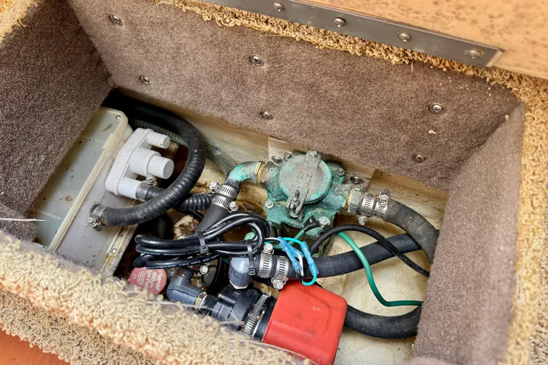 Slide: The Image of 2007 Larson Cabrio 274 boat compartment with hoses and mechanical components. - 15