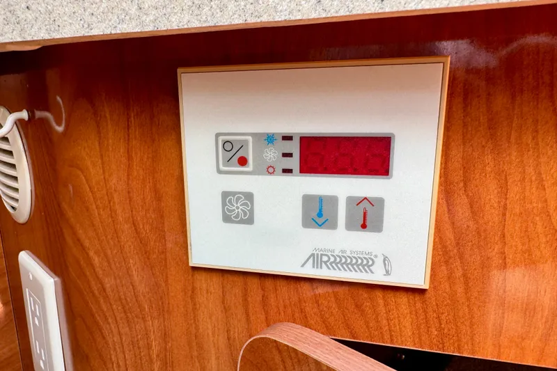 Slide: The Image of Control panel of a 2007 Larson Cabrio 274 boat, featuring temperature settings. - 16