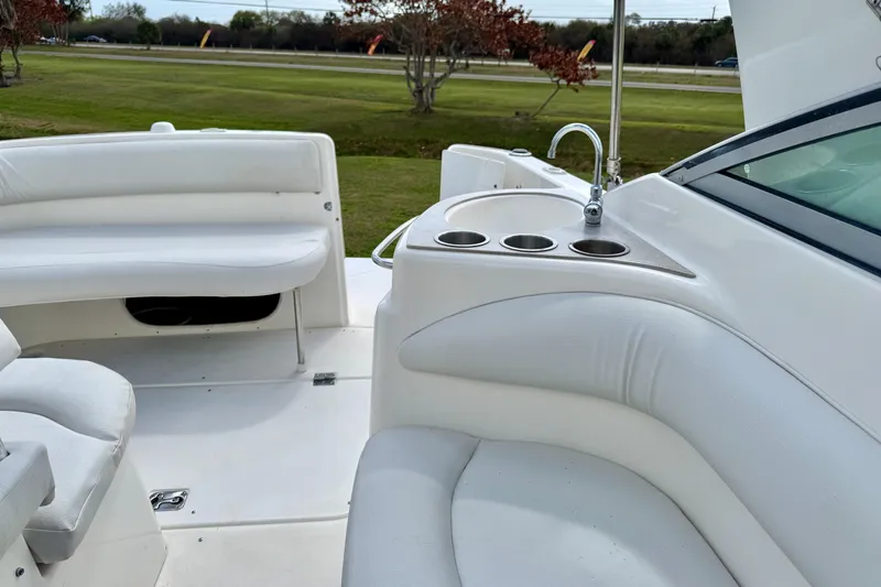 Slide: The Image of 2007 Larson Cabrio 274 boat interior with white seating and cup holders. - 20