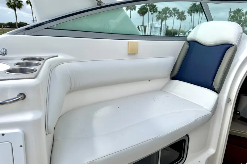 Slide: The Image of 2007 Larson Cabrio 274 boat interior with white seating and cup holders. - 21