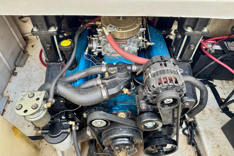 Slide: The Image of Engine compartment of a 2007 Larson Cabrio 274 boat, showcasing mechanical components. - 26