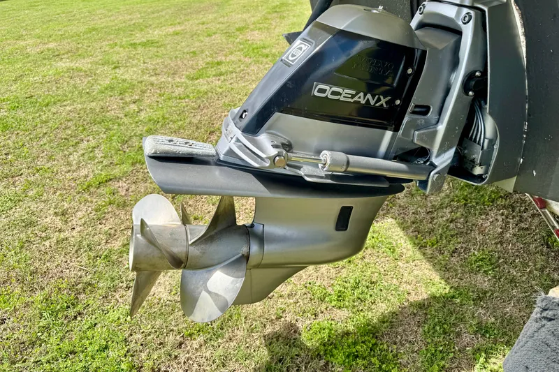 Slide: The Image of 2007 Larson Cabrio 274 boat propeller and outdrive on grassy background. - 27