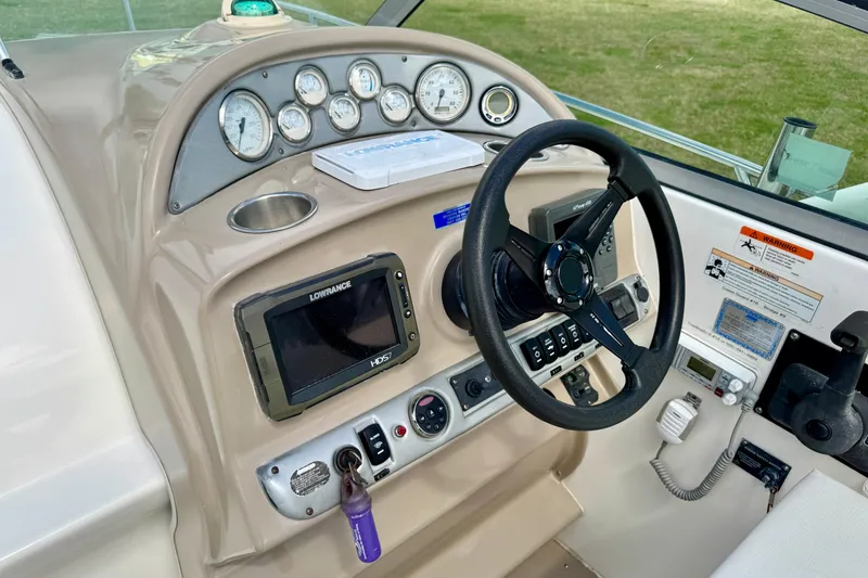 Slide: The Image of 2007 Larson Cabrio 274 boat dashboard with steering wheel, gauges, and navigation system. - 7