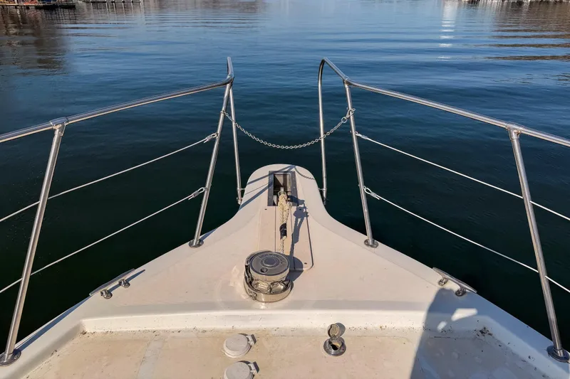 Slide: The Image of Bow view of 1985 Blue Water 51 Coastal yacht on calm water. - 13