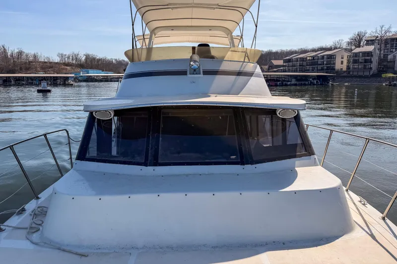 Slide: The Image of 1985 Blue Water 51 Coastal yacht docked at a marina, featuring a spacious deck. - 14