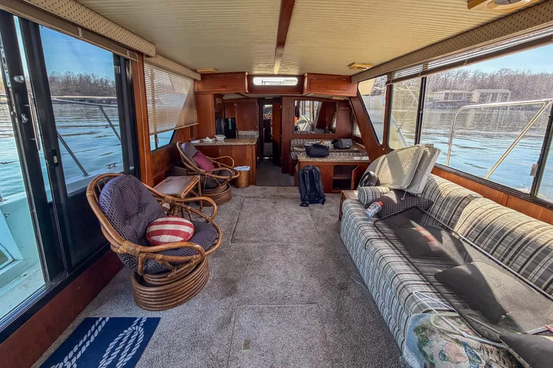 Slide: The Image of Interior of 1985 Blue Water 51 Coastal yacht with cozy seating and lake view. - 15