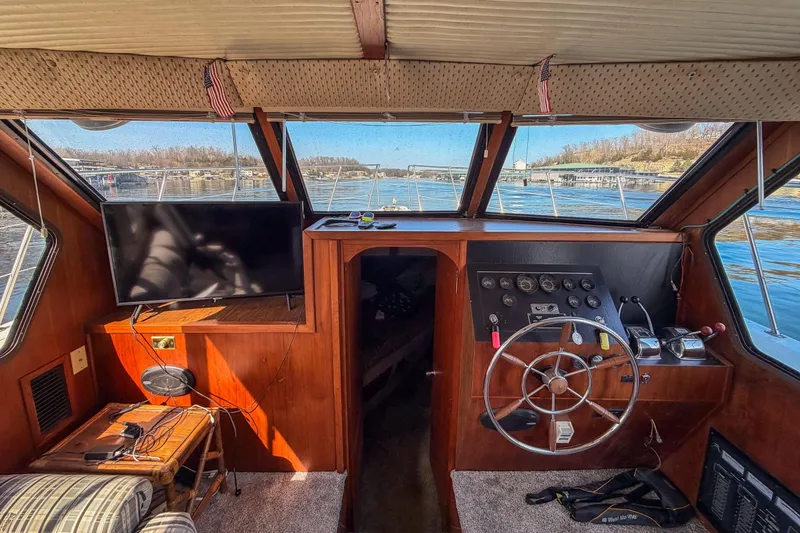 Slide: The Image of Interior view of 1985 Blue Water 51 Coastal boat with steering wheel and TV. - 16