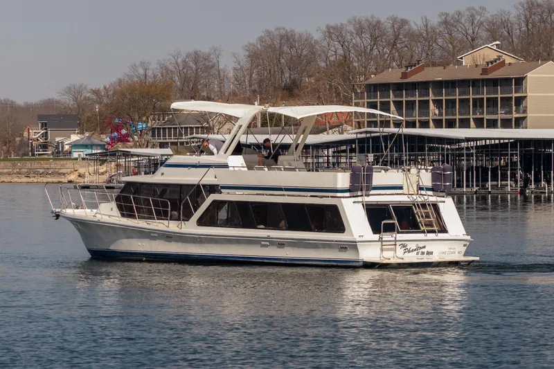 Slide: The Image of 1985 Blue Water 51 Coastal yacht cruising near a marina with buildings in the background. - 18