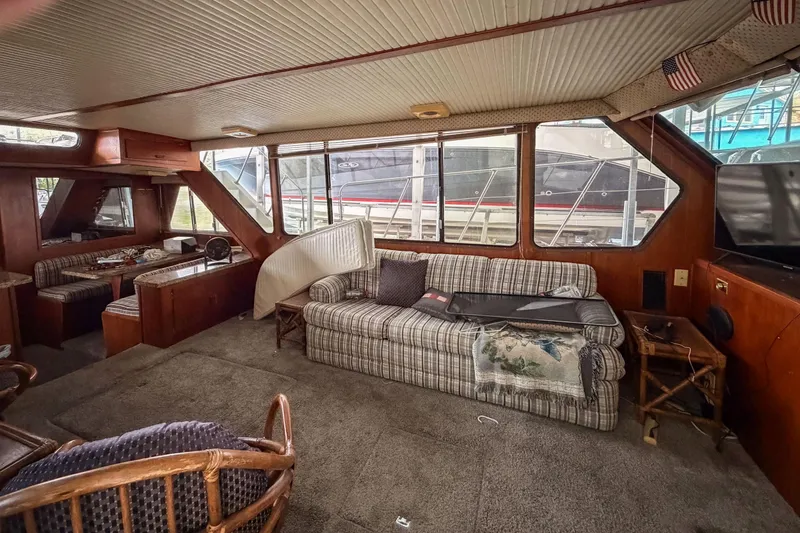 Slide: The Image of Interior of 1984 Blue Water 51 Coastal yacht with cozy seating and large windows. - 19