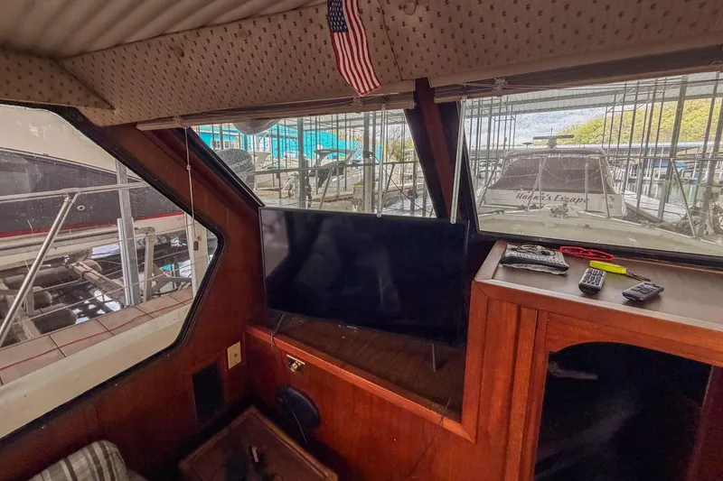 Slide: The Image of Interior of a 1984 Blue Water 51 Coastal boat with a TV and American flag. - 21