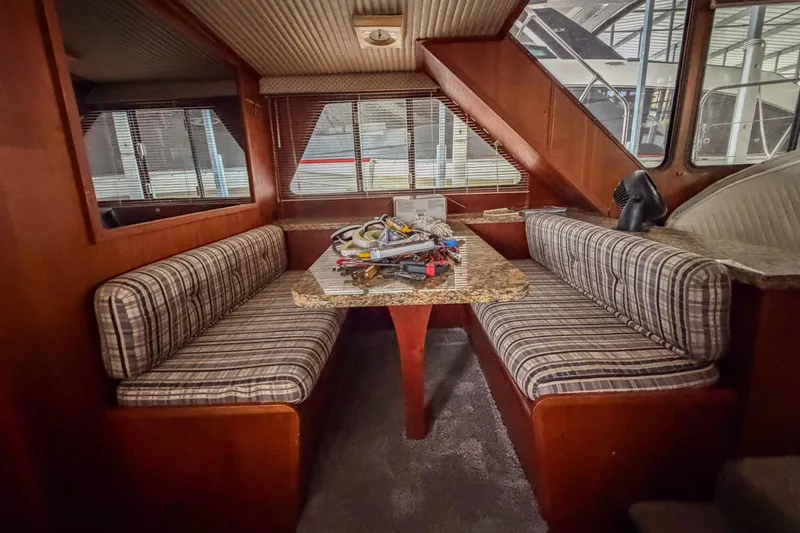 Slide: The Image of Interior of 1984 Blue Water 51 Coastal yacht with striped seating and wooden accents. - 24
