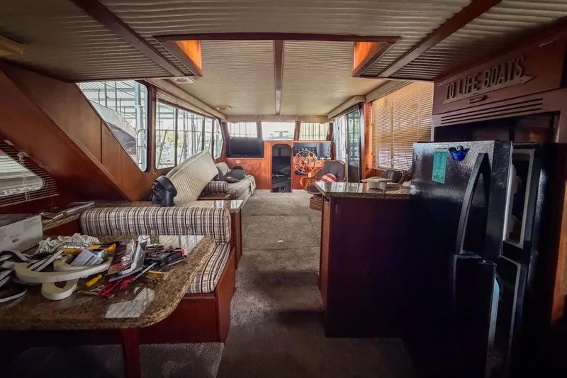 Slide: The Image of Interior of a 1984 Blue Water 51 Coastal boat with cozy seating and nautical decor. - 26